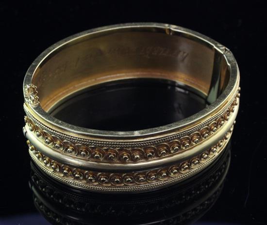 A Victorian gold hinged bracelet, in original box.